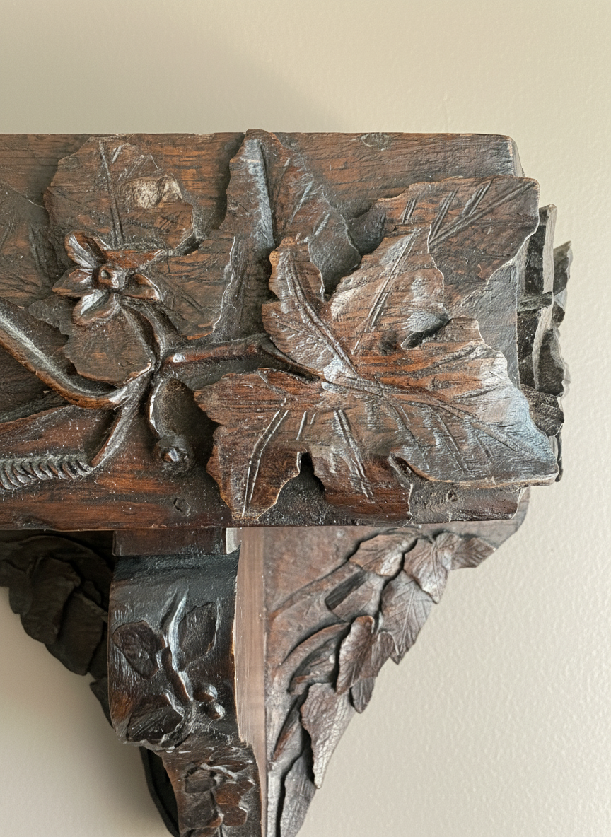 carved wall bracket with leaf decoration close up