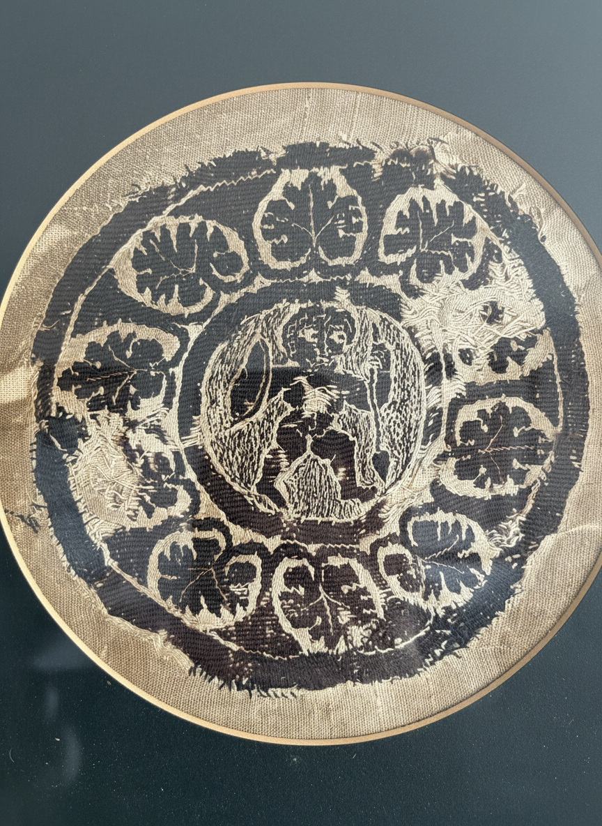 close up of framed coptic textile roundel featuring a warrior