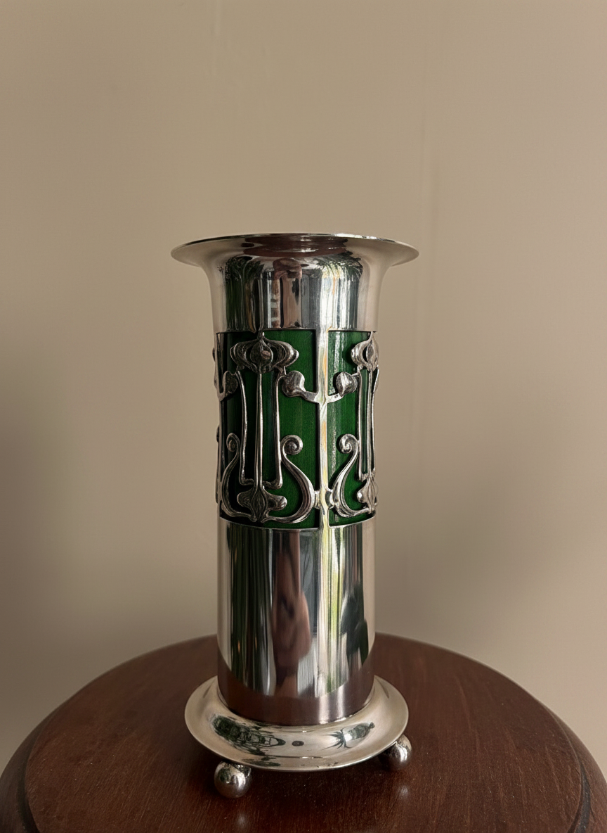 close up of a silver plated art nouveau bud vase designed by Christopher Dresser