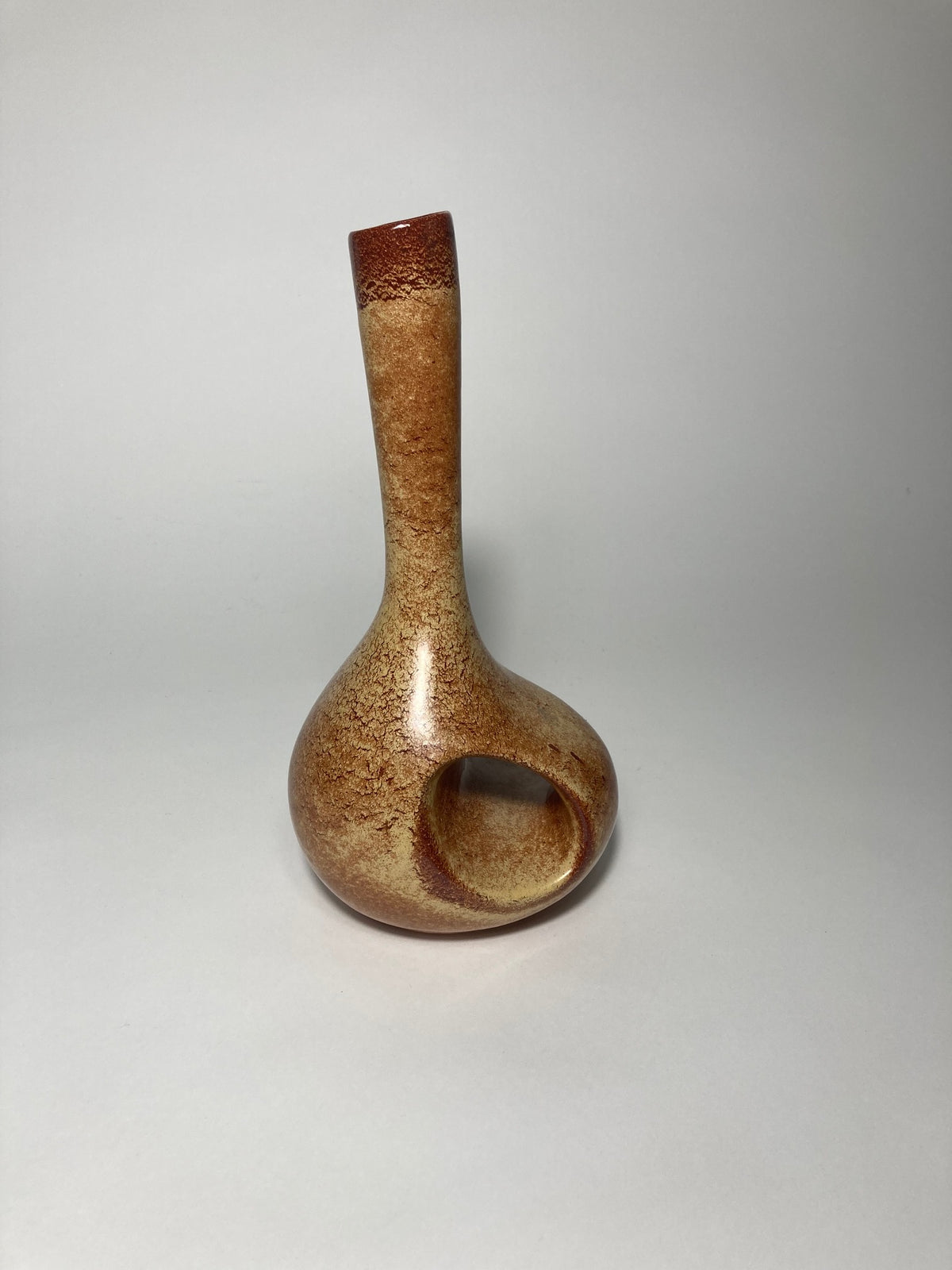Brown ceramic vase by Bertoncello on a gray studio background