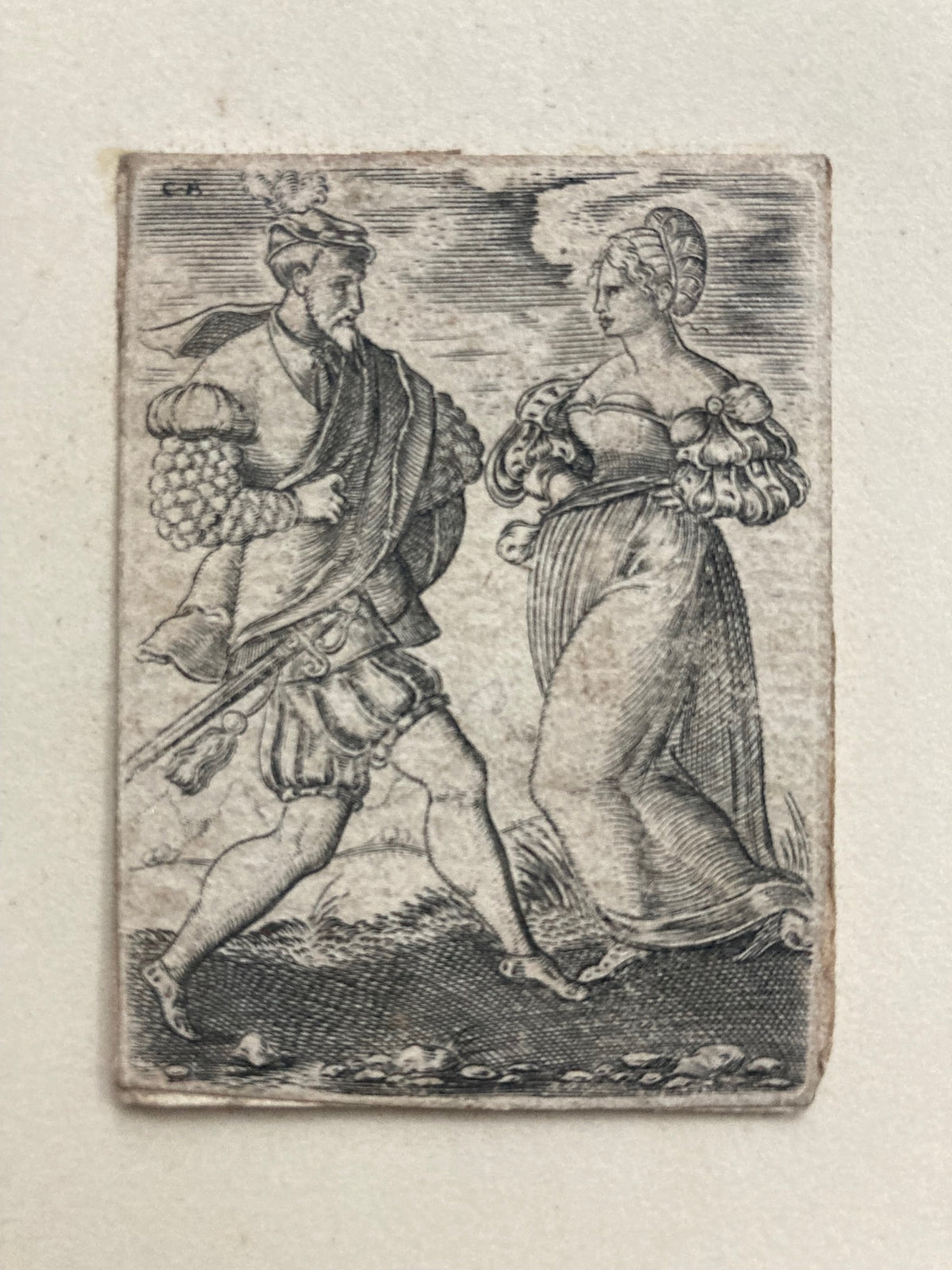 antique etching of two figures dancing on a textured beige background