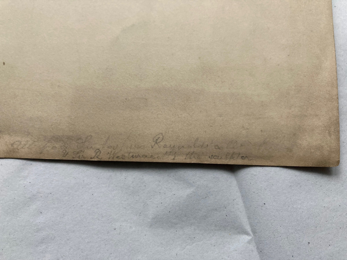 Close-up of a handwritten note that the collection came from sir Joshua Reynolds on a piece of paper with a blurred background