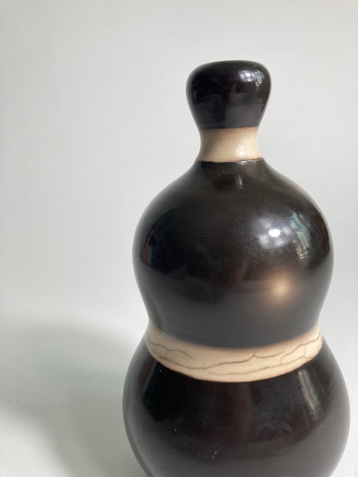A close up of Raku fired Vase by contemporary ceramic artist John Nuttgens