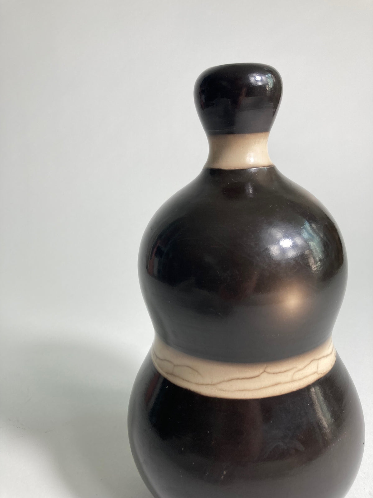 A close up of Raku fired Vase by contemporary ceramic artist John Nuttgens