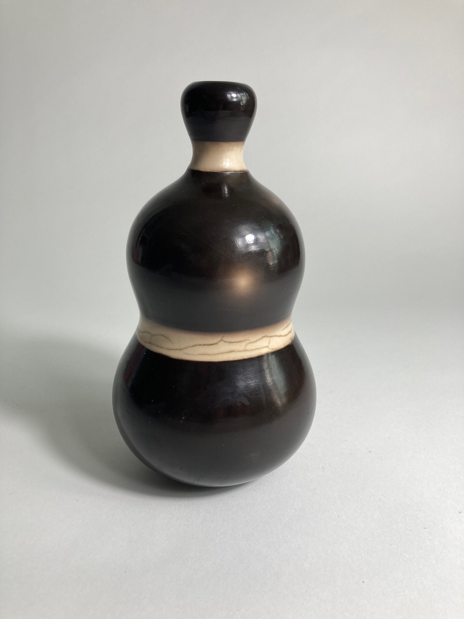 A Raku Fired Vase by contemporary ceramic artist John Nuttgens