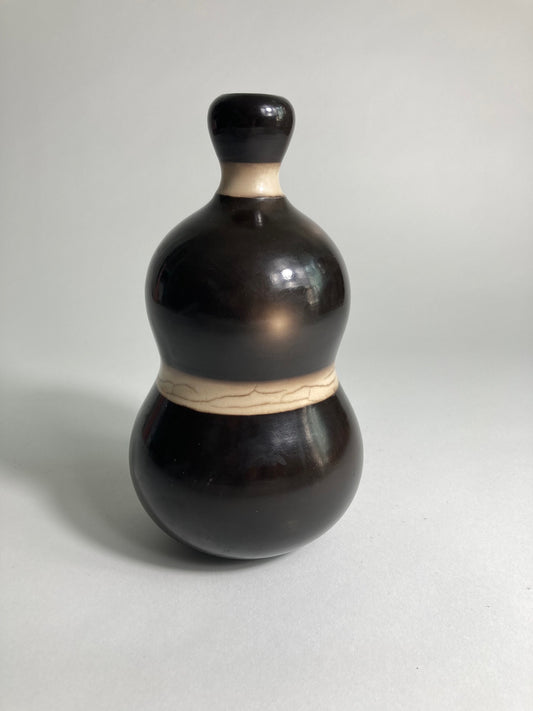 A Raku Fired Vase by contemporary ceramic artist John Nuttgens