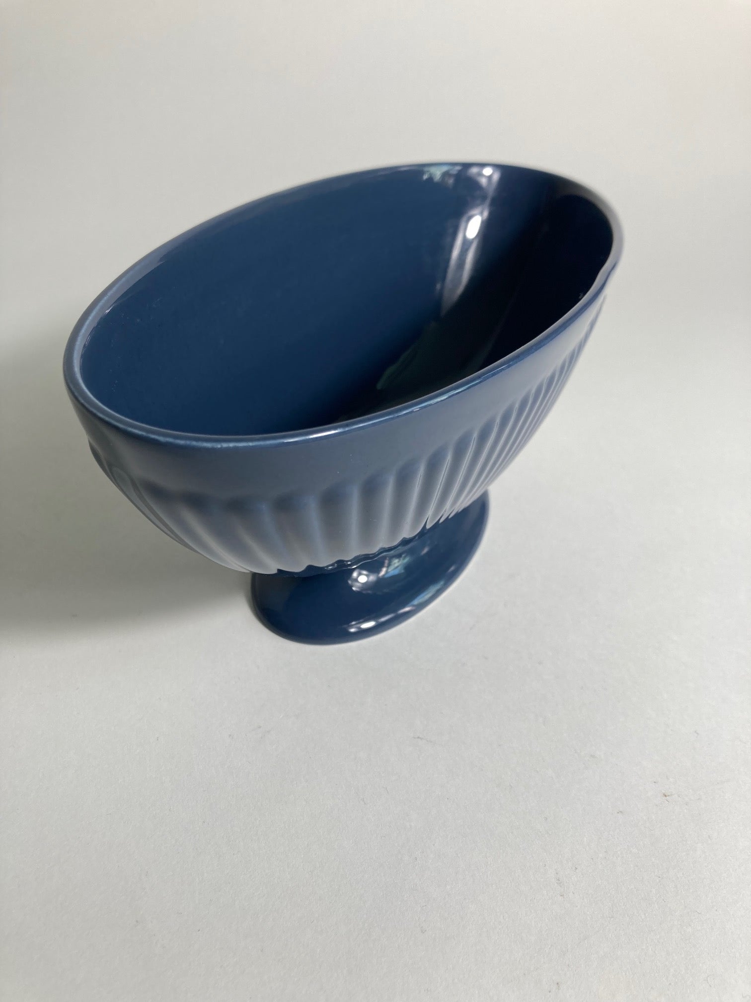 A navy planter produced by Wedgewood and designed by Keith Murray. Side view