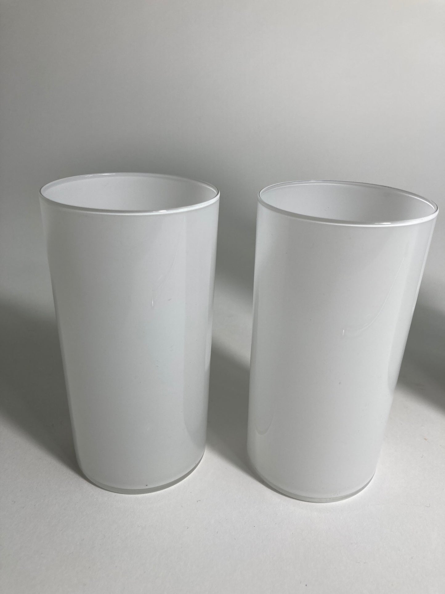 A pair of white milk glasse by Timo Sarpeneva for Littala Glass