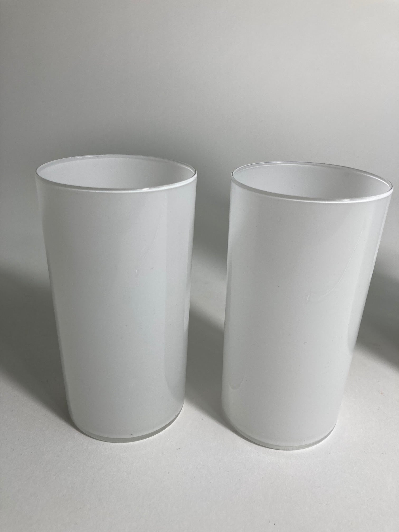 A pair of white milk glasse by Timo Sarpeneva for Littala Glass