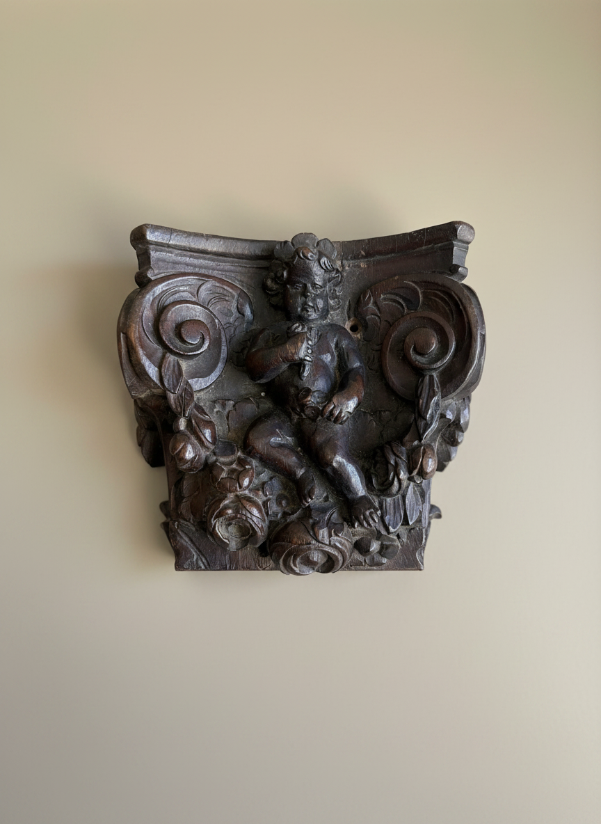 wood carving on a taupe coloured wall