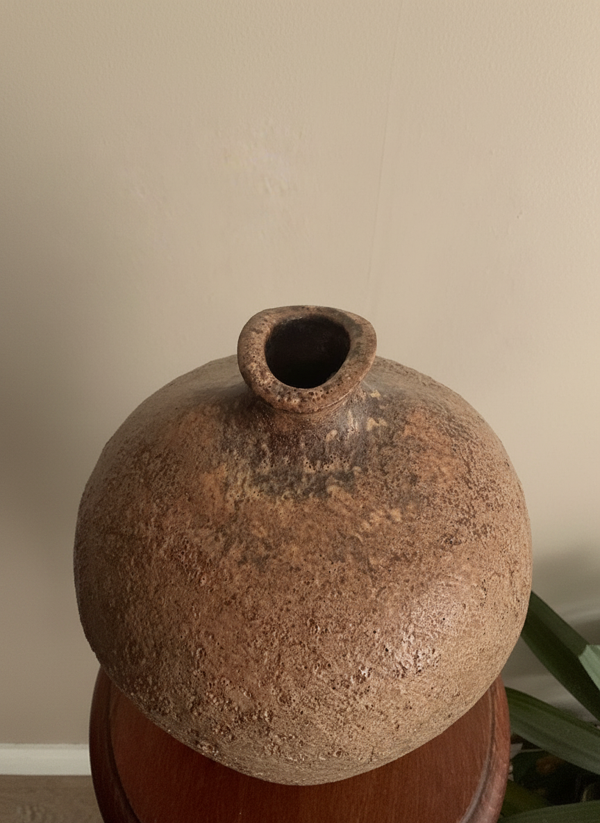 view from above of a textured vase by chris carter against a taupe coloured wall