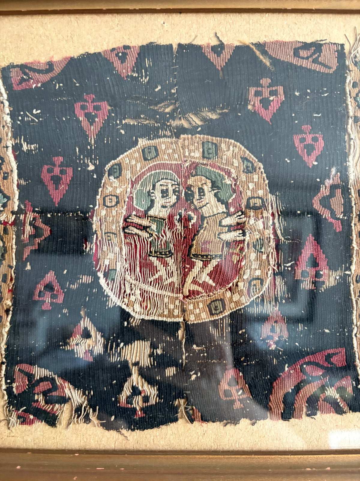 close up of framed coptic textile featuring two figures