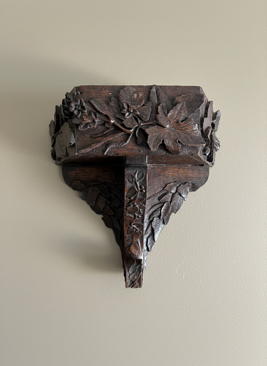 carved Black Forest wall bracket on a taupe coloured wall
