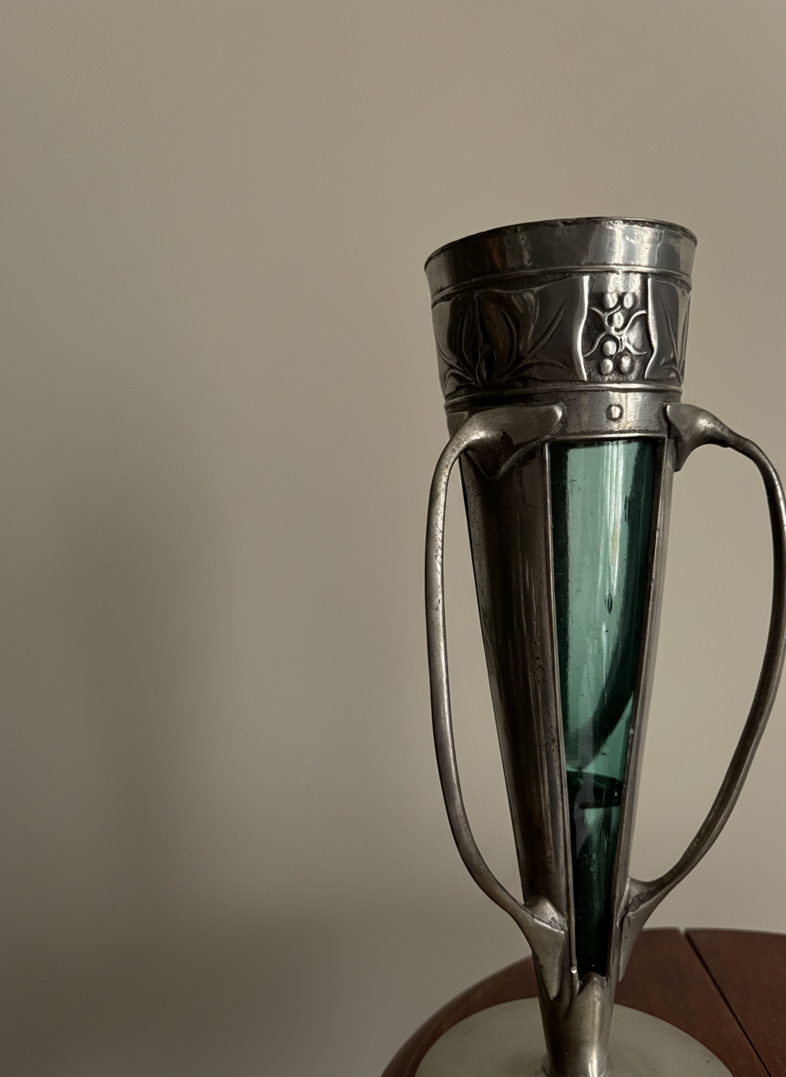 close up of an archibald knox taupe vase